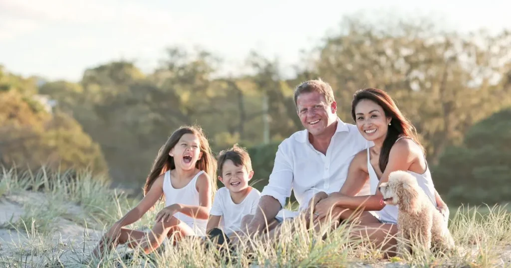 Parents and children sharing a warm family moment that reflects the connection and trust encouraged by gentle parenting.