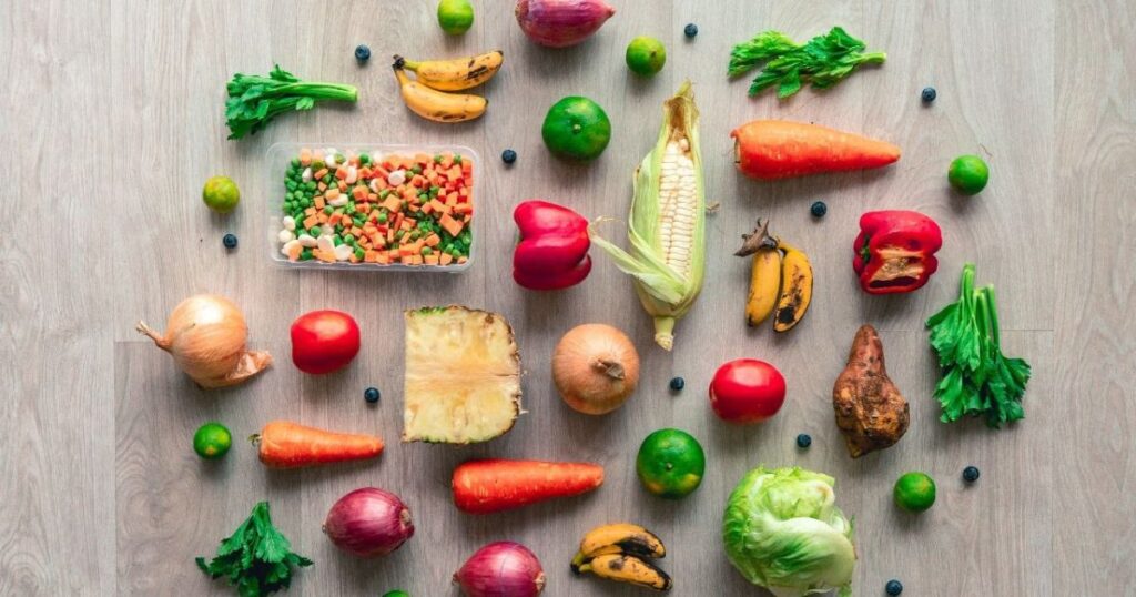 Healthy colorful foods arranged on a wooden table.