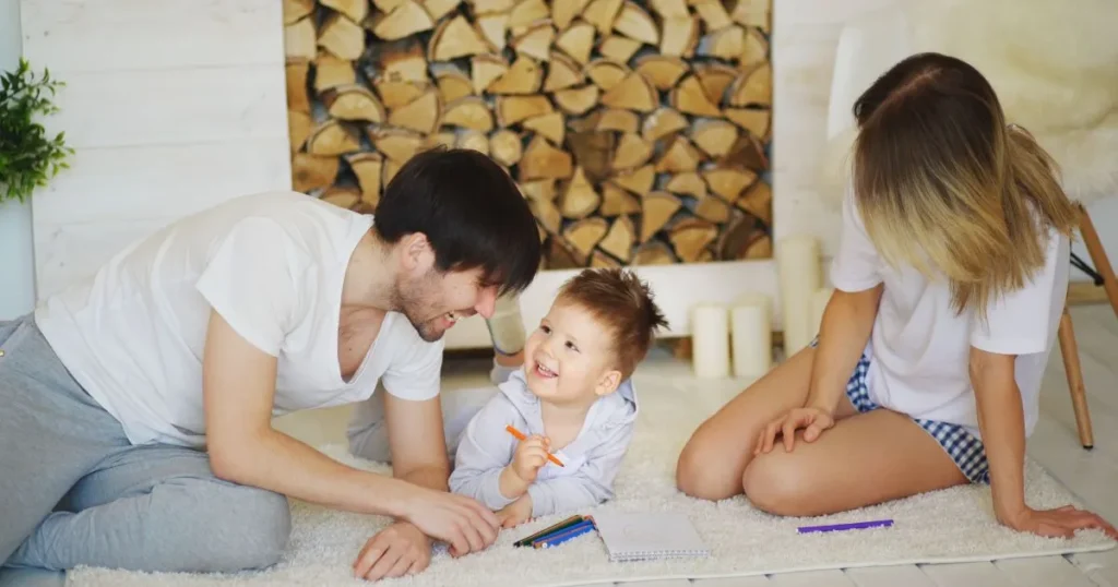 Parents supporting their child during a creative learning activity at home