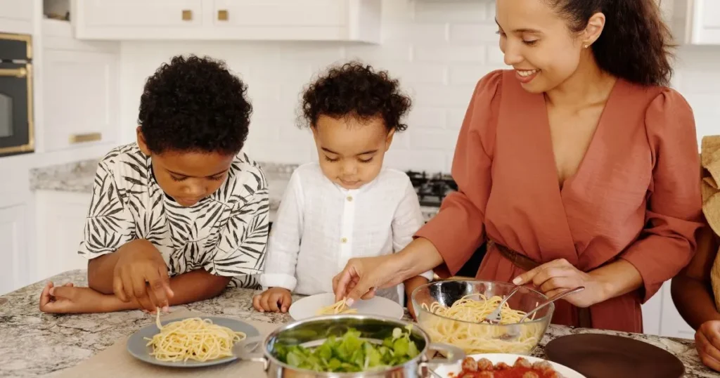 Mother preparing a healthy meal while spending time with her toddler