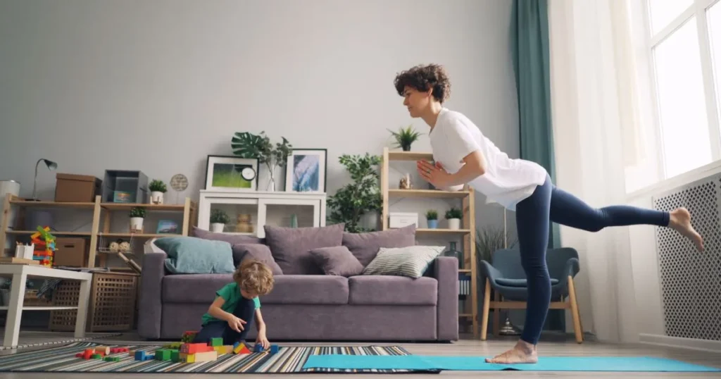 Mother practicing sport while supervising her child