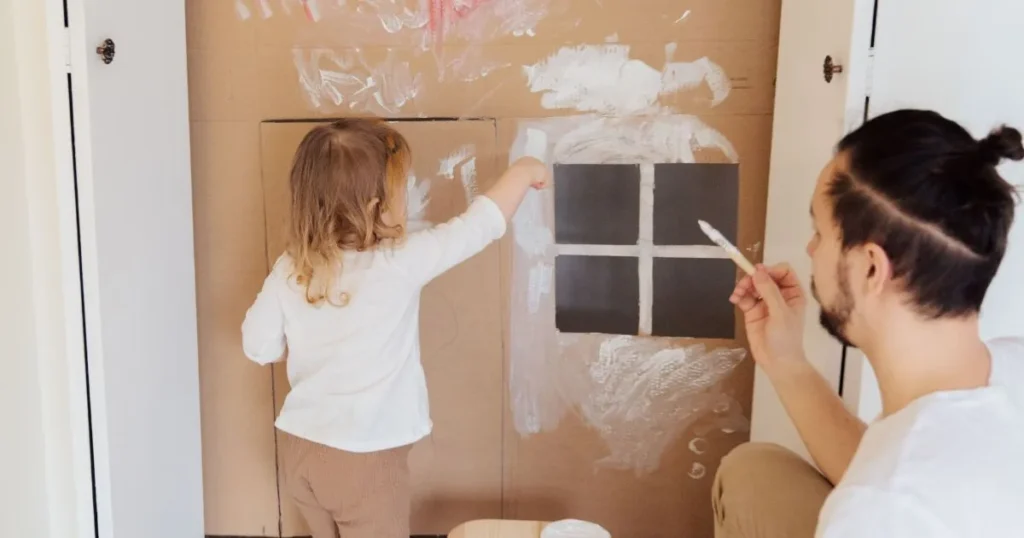 Parents encouraging creativity through a shared family activity.