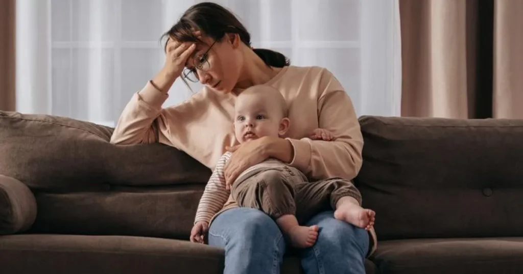 Tired mother feeling emotionally exhausted after a busy morning with her children