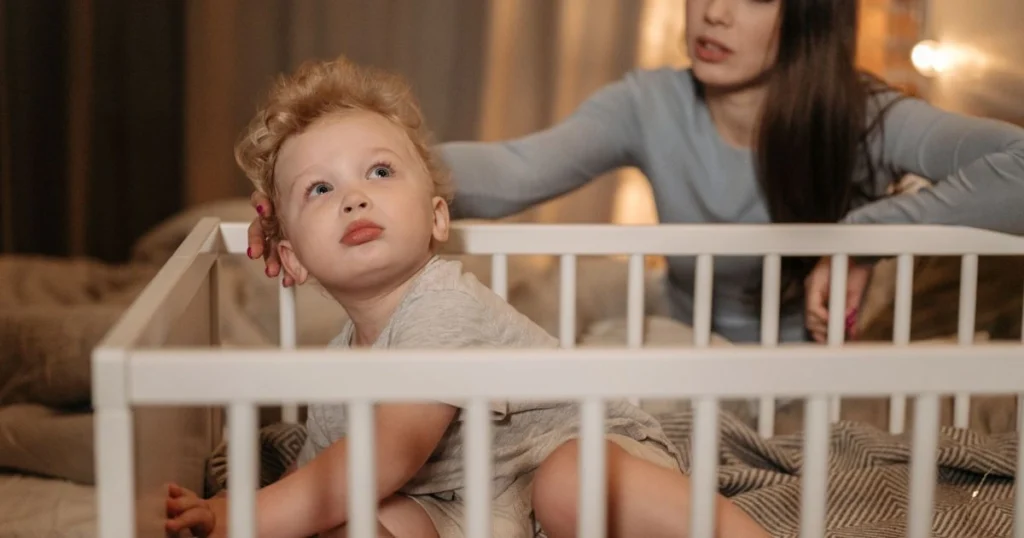 Toddler experiencing separation anxiety at bedtime during the 18 month sleep regression.