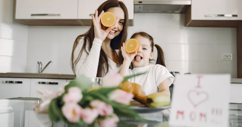 Happy mother smiling and spending a warm, joyful moment with her young daughter at home.