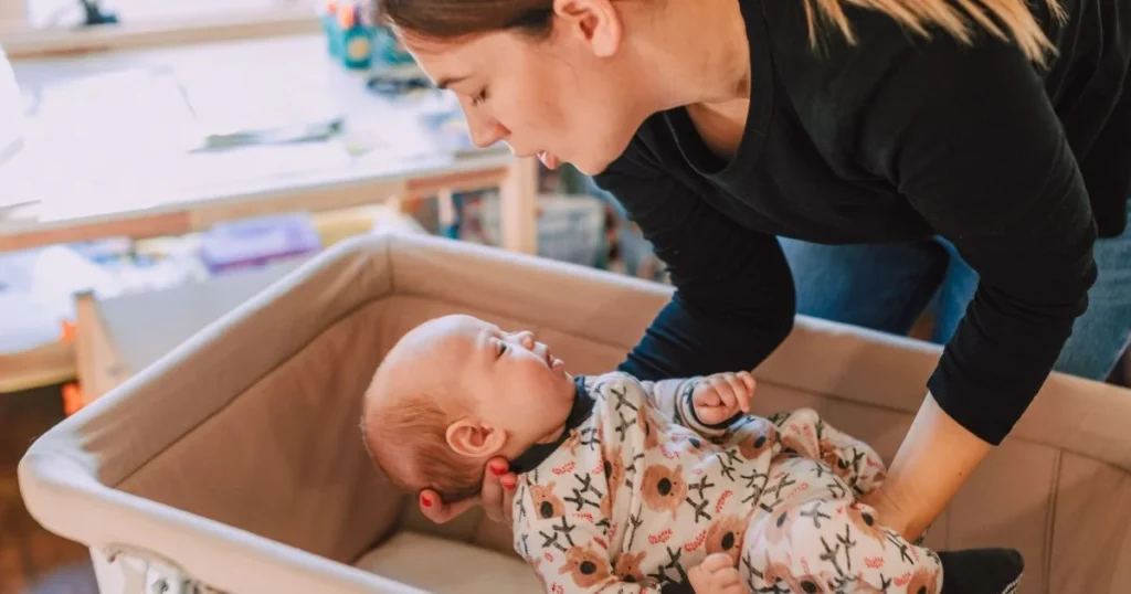 Baby Girl Names: 250+ Beautiful Ideas for Your Baby 5 Parent gently holding a newborn baby girl at home