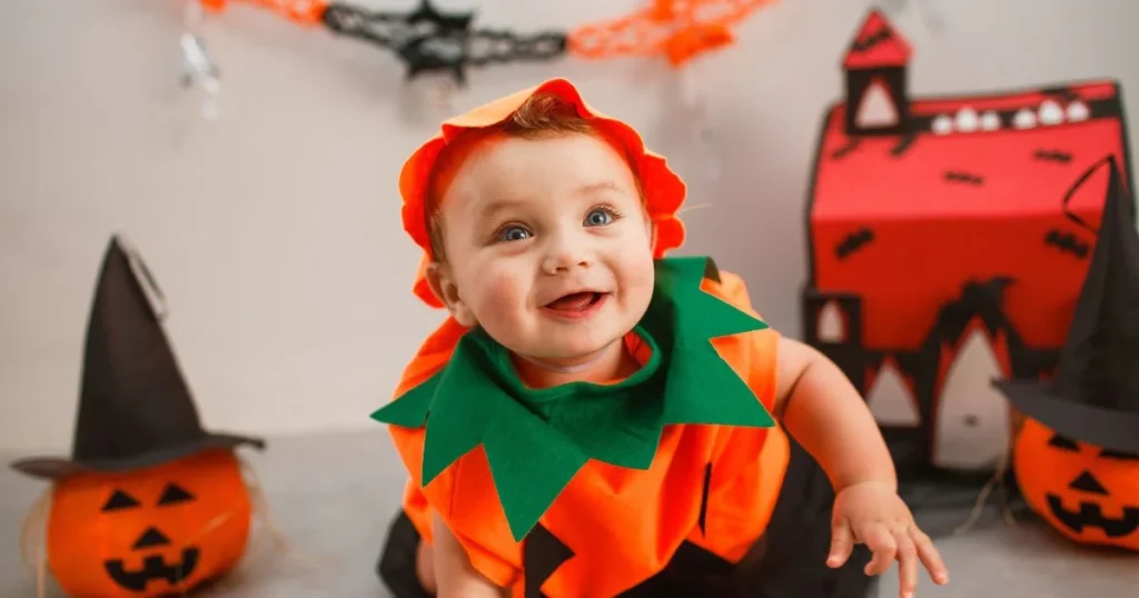 Baby in Pumpkin: The Ultimate Photoshoot Guide, Tips, Safety & Setup 7 Baby wearing a cozy autumn outfit beside a pumpkin for Halloween pictures.