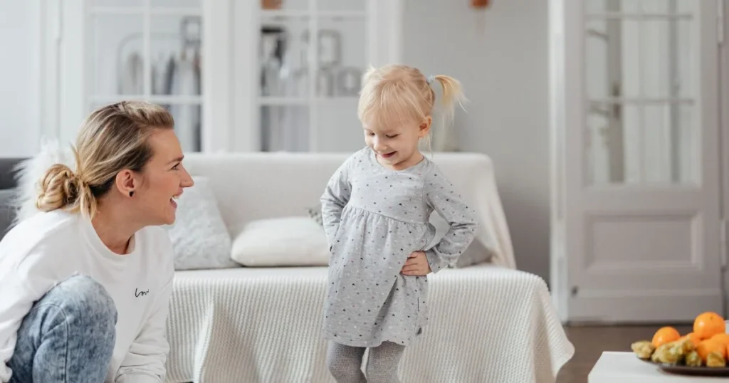 Tattling: How to Respond When Your Child Tells on Others 3 Mother listening calmly as toddler talks about a minor conflict