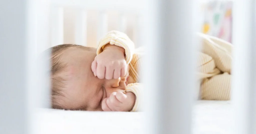 Baby Girl Names: 250+ Beautiful Ideas for Your Baby 4 Newborn baby girl resting in a neutral nursery