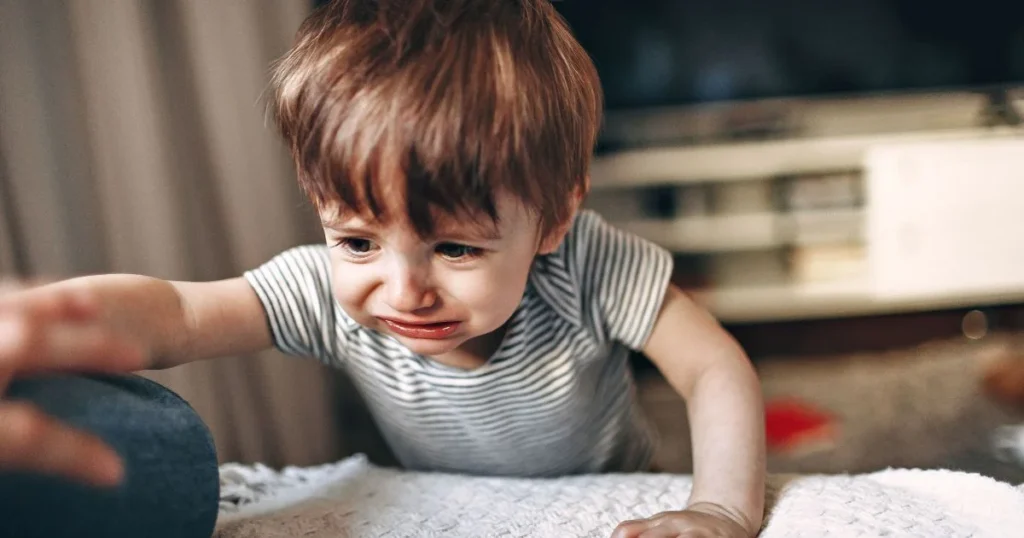  an upset toddler who is trying to hit